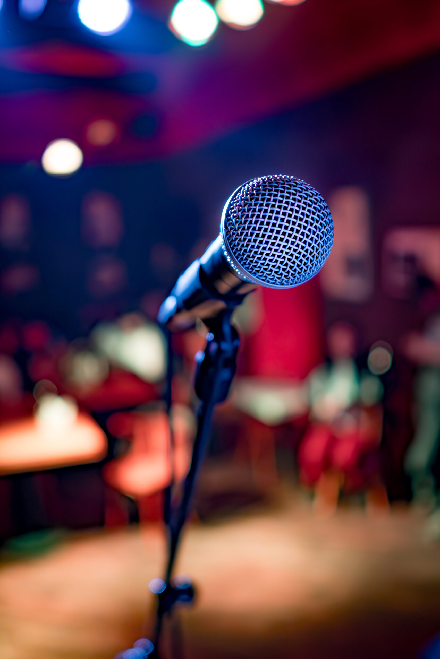 Public performance on stage Microphone on stage against a background of auditorium. Shallow depth of field.